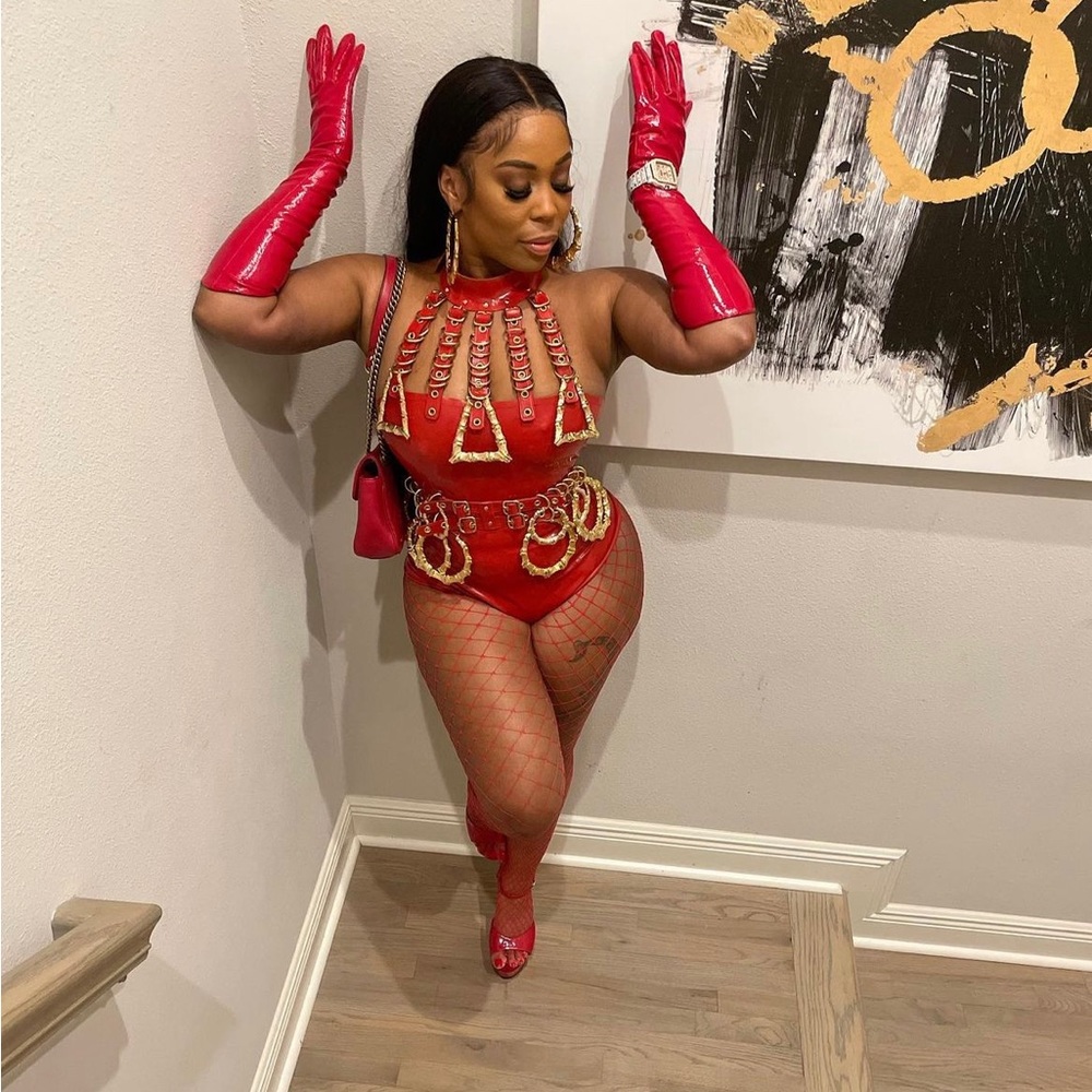 Red latex body suite sold with gloves to Match gold hoop earrings were removed